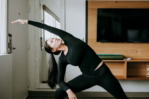 Girl doing yoga in guest room