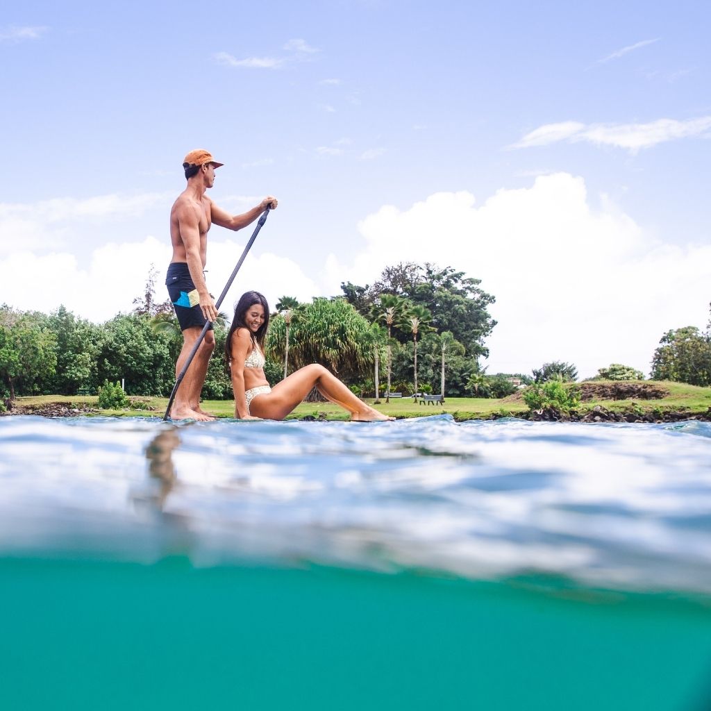 Couple paddleboarding on Hilo Bay