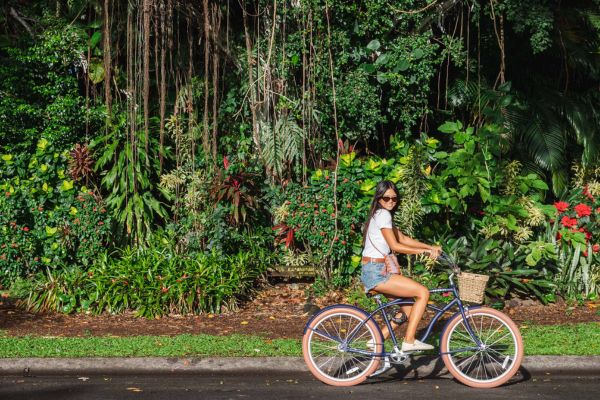 Woman riding a bike on Banyan Drive in Hilo