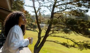 Woman overlooking greenery at Salishan Coastal Lodge by SCP Hotels